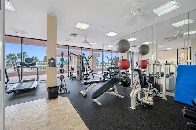 workout area featuring expansive windows and ceiling fan