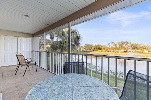 sunroom featuring a healthy amount of sunlight and a water view