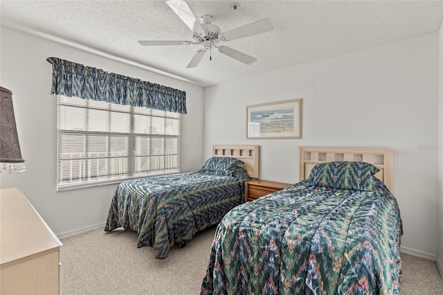 bedroom with carpet, a textured ceiling, and ceiling fan