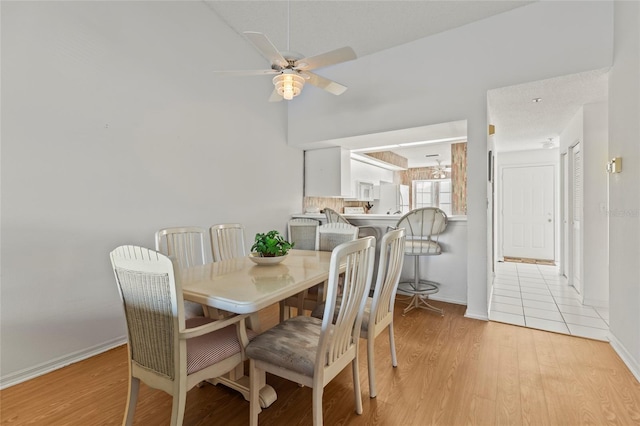 dining space featuring ceiling fan and light hardwood / wood-style flooring