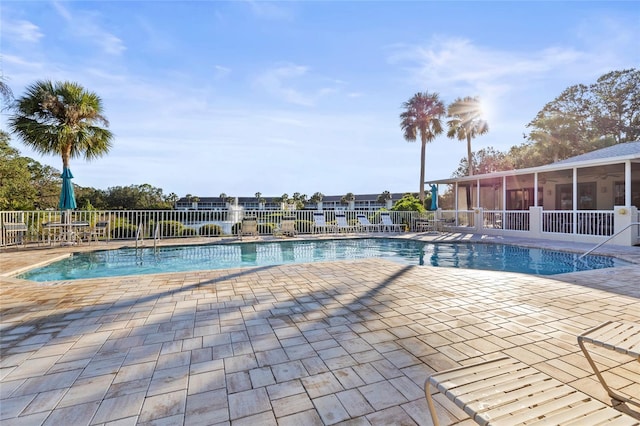 view of pool featuring a patio area and a sunroom