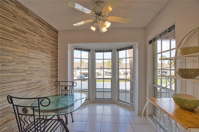 201 Silver Lake Dr Unit 204, Venice, FL 34292 - doorway to outside with a ceiling fan, a textured ceiling, an accent wall, and wooden walls