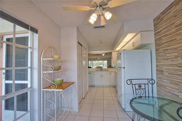 201 Silver Lake Dr Unit 204, Venice, FL 34292 - kitchen featuring visible vents, freestanding refrigerator, dishwashing machine, white cabinets, and a sink