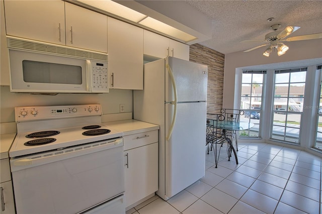 201 Silver Lake Dr Unit 204, Venice, FL 34292 - kitchen with ceiling fan, a textured ceiling, light countertops, white appliances, and white cabinetry