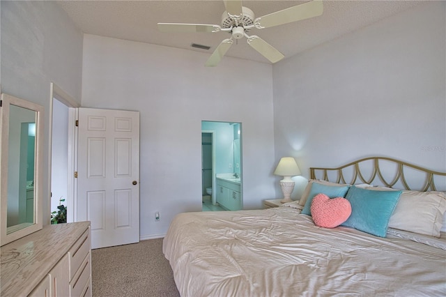 201 Silver Lake Dr Unit 204, Venice, FL 34292 - carpeted bedroom featuring ceiling fan, ensuite bath, baseboards, and a towering ceiling