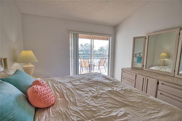 201 Silver Lake Dr Unit 204, Venice, FL 34292 - bedroom with access to outside, a textured ceiling, and lofted ceiling