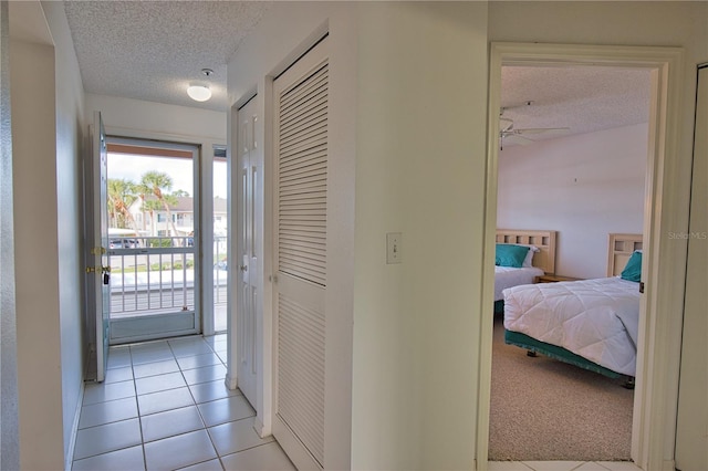 201 Silver Lake Dr Unit 204, Venice, FL 34292 - hallway with light tile patterned flooring and a textured ceiling
