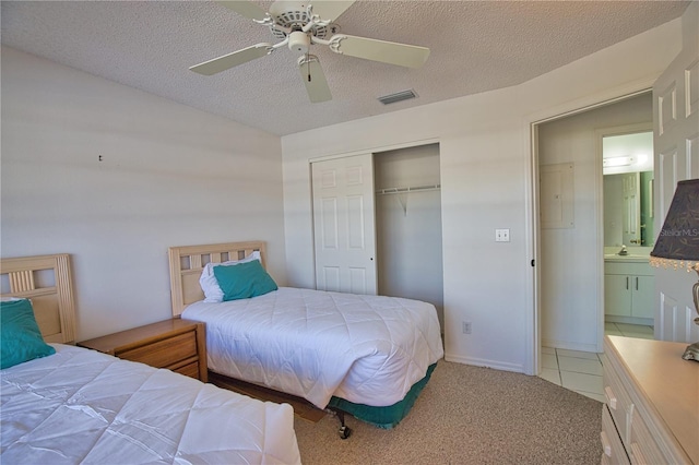 201 Silver Lake Dr Unit 204, Venice, FL 34292 - bedroom featuring light carpet, a sink, a textured ceiling, visible vents, and a closet