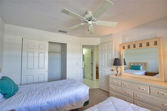 201 Silver Lake Dr Unit 204, Venice, FL 34292 - bedroom featuring ceiling fan, a closet, a textured ceiling, and visible vents