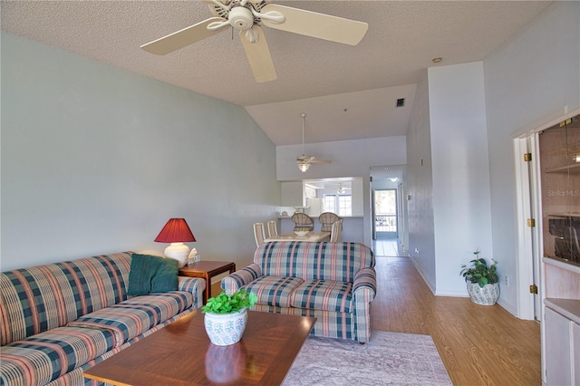 201 Silver Lake Dr Unit 204, Venice, FL 34292 - living area featuring a ceiling fan, baseboards, wood finished floors, and lofted ceiling