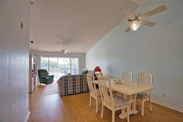 201 Silver Lake Dr Unit 204, Venice, FL 34292 - dining area featuring ceiling fan, a textured ceiling, vaulted ceiling, wood finished floors, and baseboards