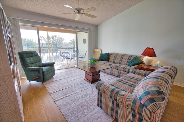 201 Silver Lake Dr Unit 204, Venice, FL 34292 - living area featuring a textured ceiling, ceiling fan, and wood finished floors