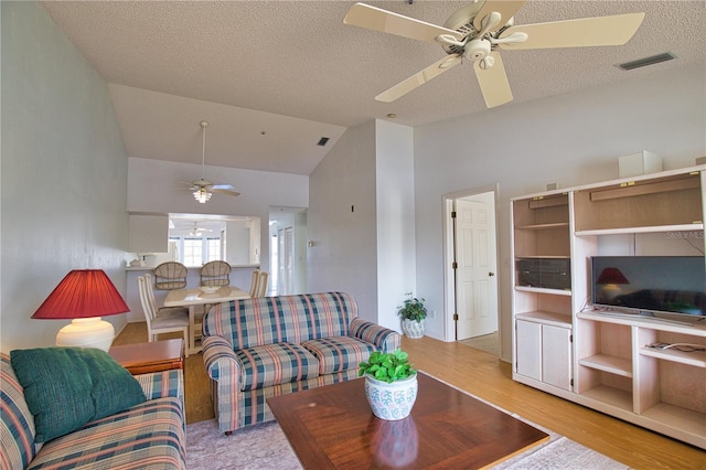 201 Silver Lake Dr Unit 204, Venice, FL 34292 - living area with ceiling fan, vaulted ceiling, wood finished floors, and visible vents