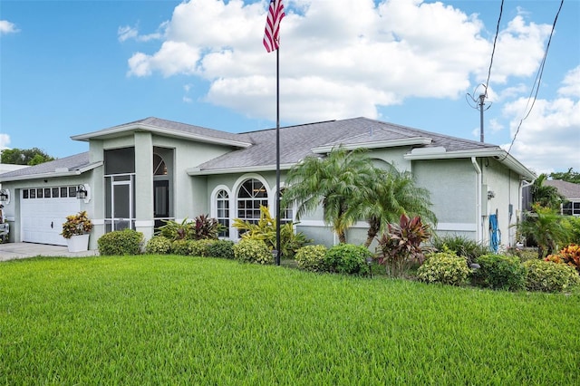 view of front of house with a front lawn and a garage