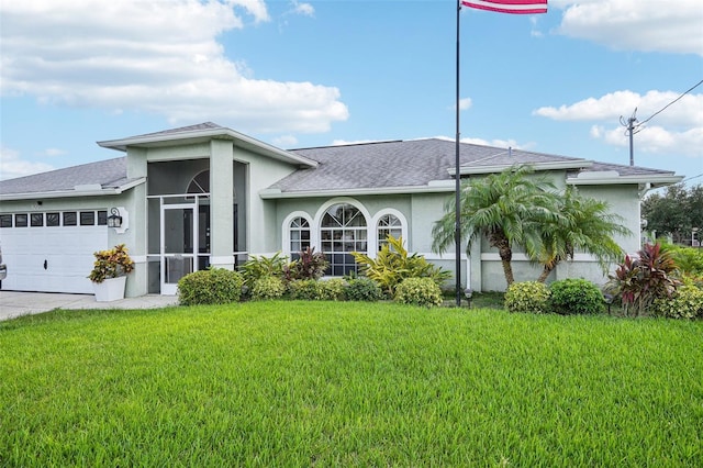 view of front facade with a front yard and a garage