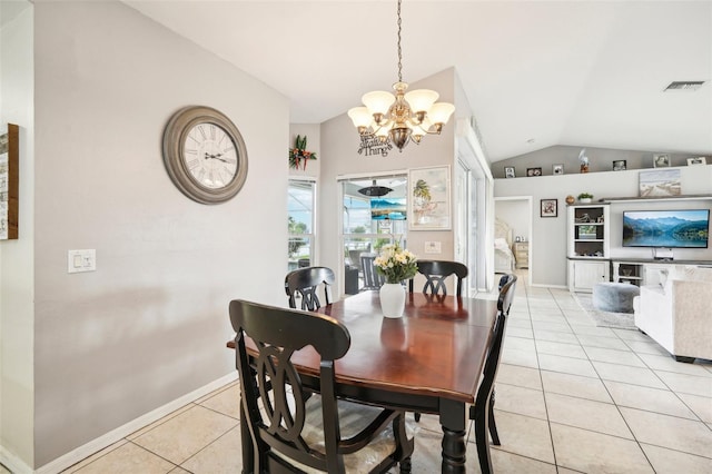 tiled dining area featuring a chandelier and lofted ceiling