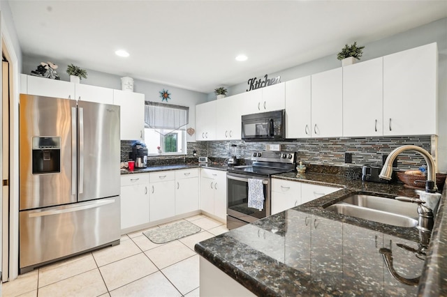 kitchen featuring decorative backsplash, stainless steel appliances, white cabinetry, and sink