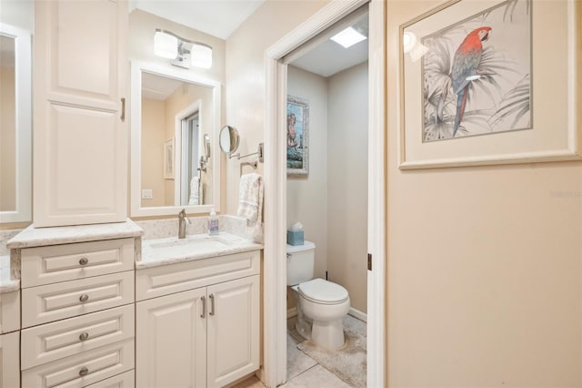 bathroom featuring tile patterned flooring, vanity, and toilet