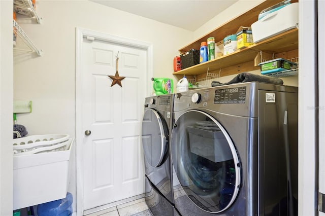 laundry area with washing machine and dryer and light tile patterned flooring