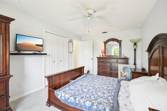 bedroom featuring ceiling fan, light tile patterned floors, and a closet