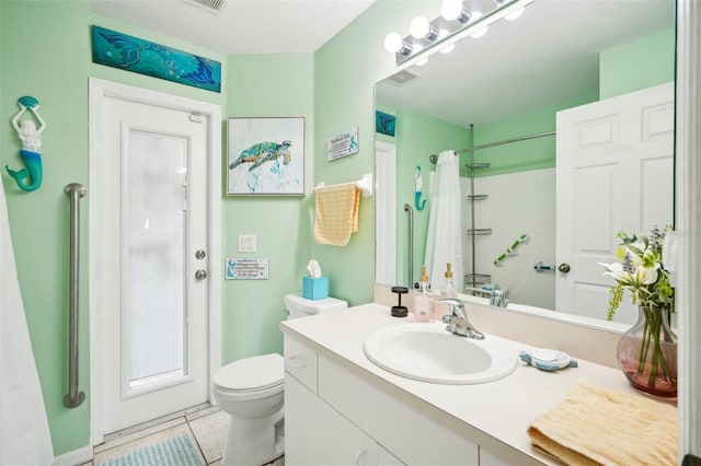 bathroom featuring a shower with shower curtain, vanity, toilet, and tile patterned floors