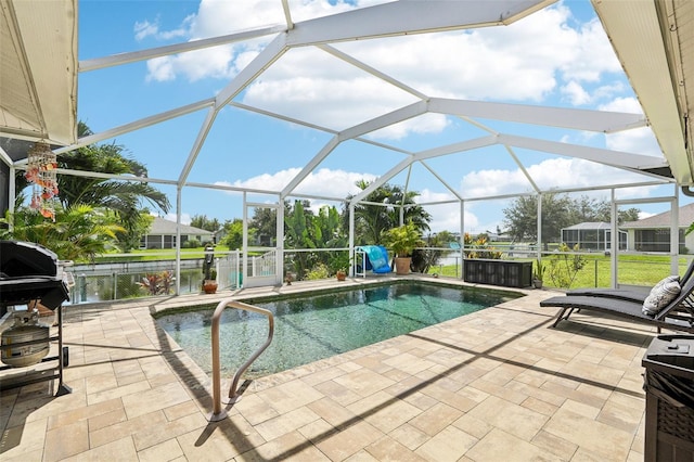 view of pool with a lanai, a patio area, and a water view