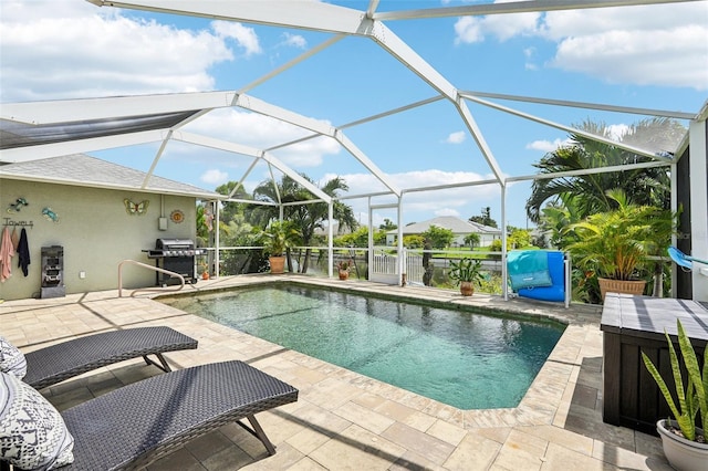 view of pool with area for grilling, a lanai, and a patio area