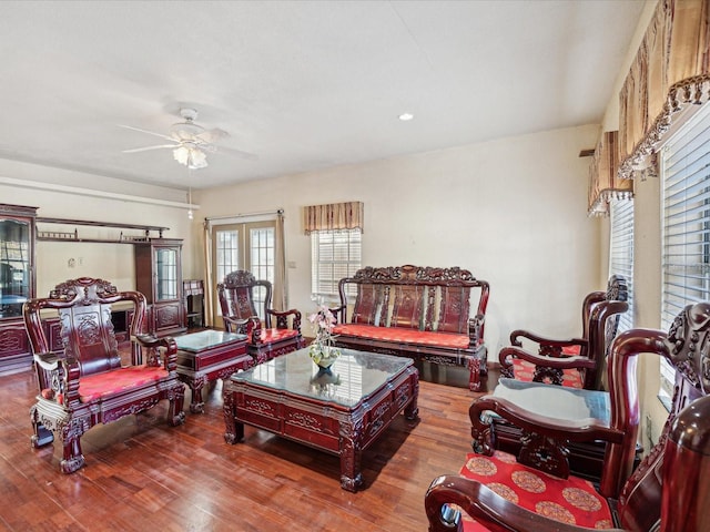 living room featuring hardwood / wood-style floors, ceiling fan, and french doors