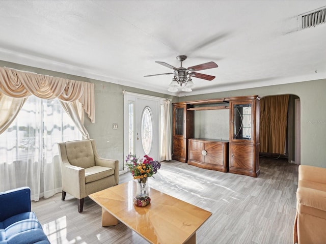 living room featuring ceiling fan and light hardwood / wood-style flooring