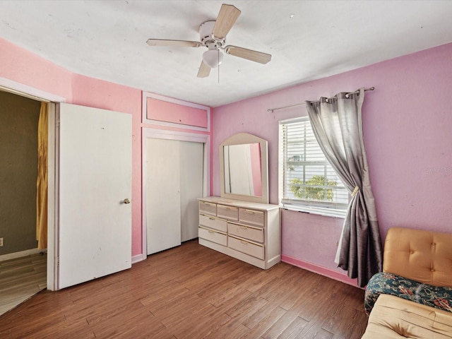 unfurnished bedroom with ceiling fan, a closet, and light hardwood / wood-style flooring