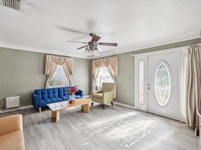 foyer entrance featuring ceiling fan