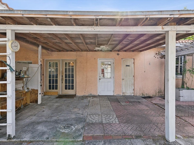 doorway to property featuring a patio area, ceiling fan, and french doors