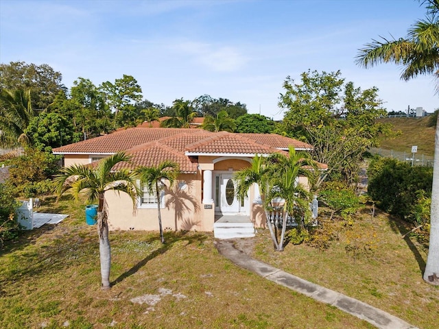 mediterranean / spanish-style home with a front yard