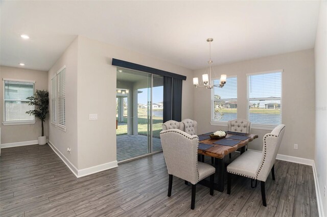 dining room featuring a healthy amount of sunlight, baseboards, and wood finished floors