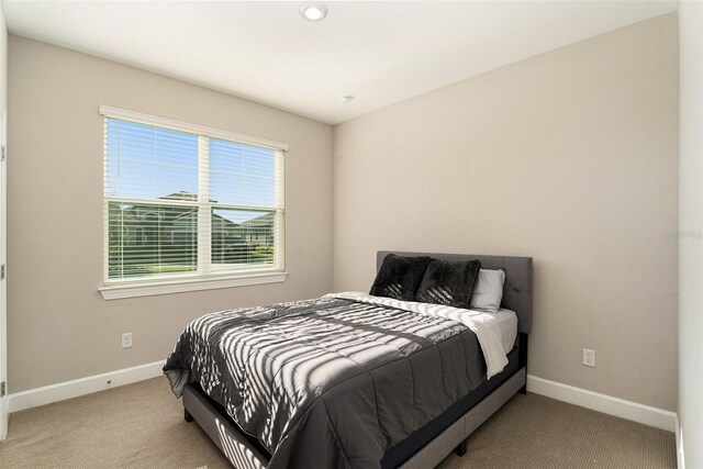 bedroom with carpet floors and baseboards