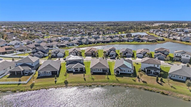 drone / aerial view featuring a residential view and a water view