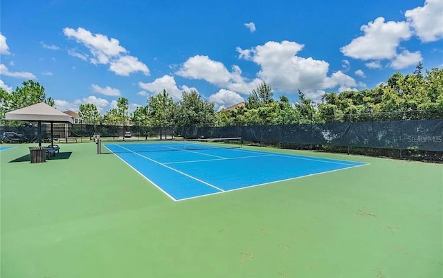 view of sport court featuring fence