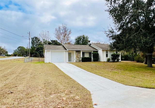 ranch-style home with a front lawn and a garage