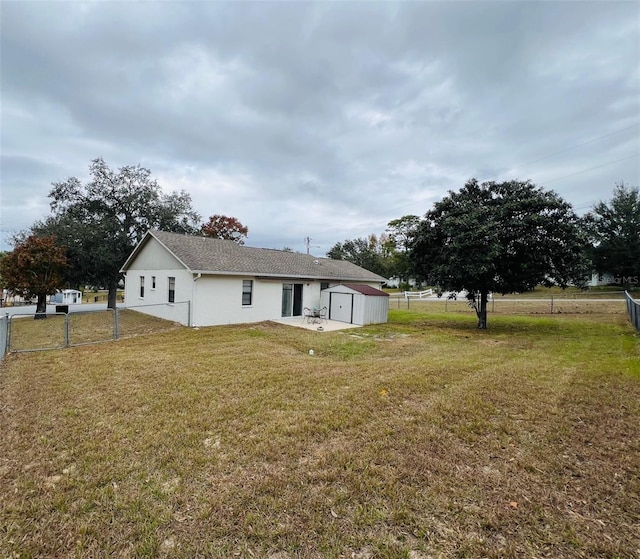 rear view of house featuring a lawn and a patio area