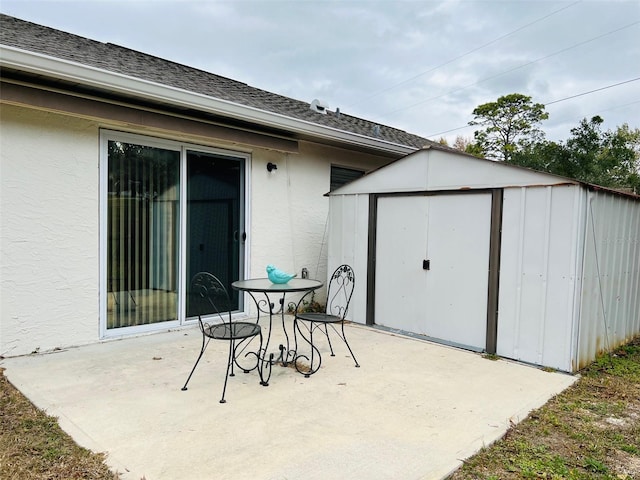 view of patio / terrace featuring an outbuilding and a storage shed