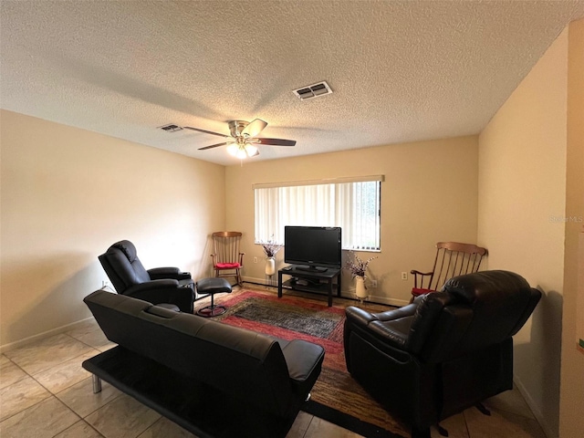 tiled living room with a textured ceiling and ceiling fan