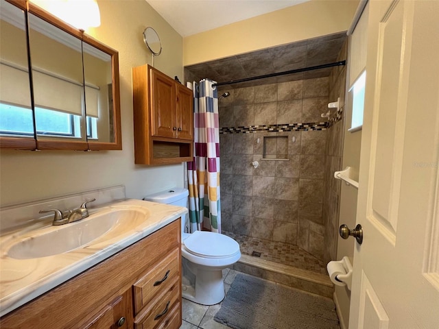 bathroom featuring tile patterned floors, vanity, curtained shower, and toilet