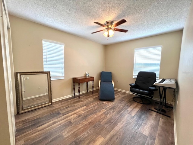 sitting room featuring a textured ceiling, dark hardwood / wood-style flooring, and ceiling fan