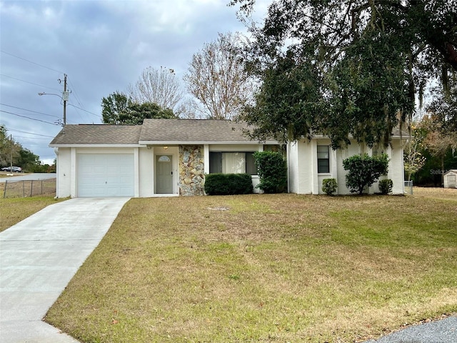 view of front of property featuring stucco siding, a front lawn, concrete driveway, a shingled roof, and a garage