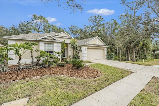 view of front of property with a garage and a front lawn