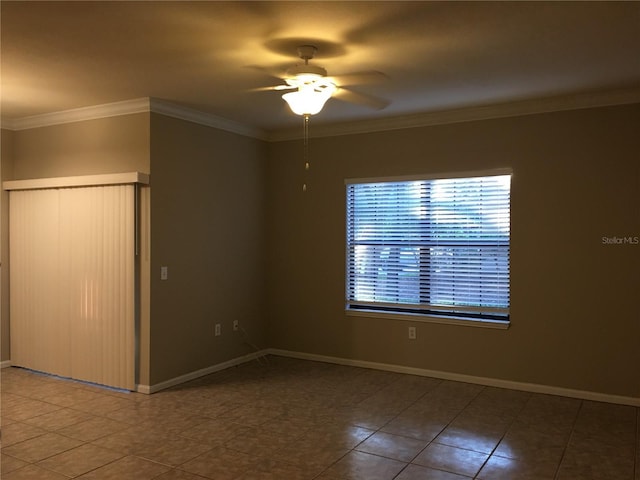 spare room featuring tile patterned floors, ceiling fan, and crown molding