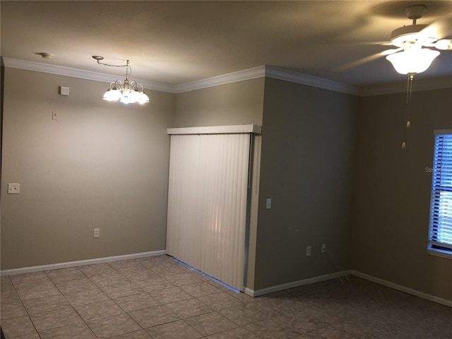 tiled empty room with ceiling fan with notable chandelier and crown molding