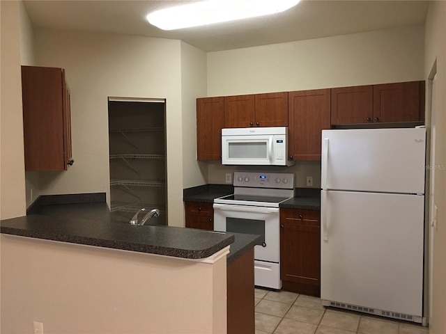 kitchen with kitchen peninsula, sink, light tile patterned floors, and white appliances