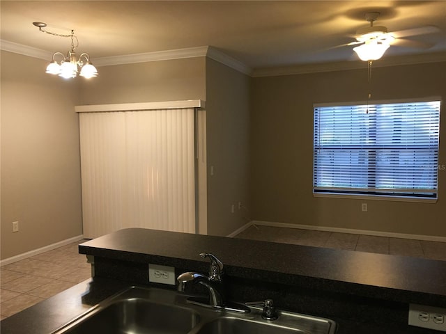 kitchen featuring ceiling fan with notable chandelier, tile patterned floors, ornamental molding, and sink