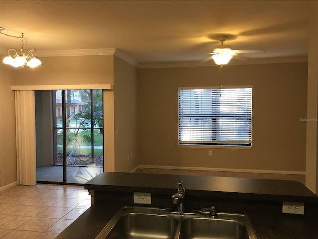 kitchen featuring ornamental molding, ceiling fan with notable chandelier, sink, light tile patterned floors, and hanging light fixtures